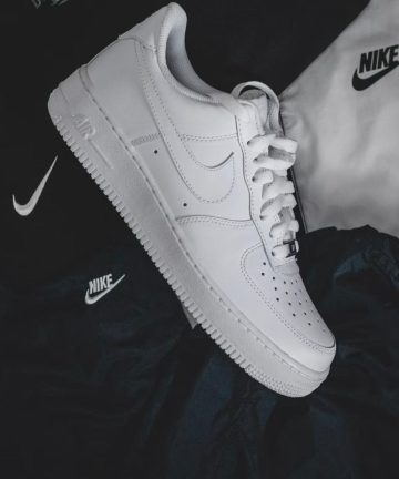 White sneaker resting on black and white athletics clothing